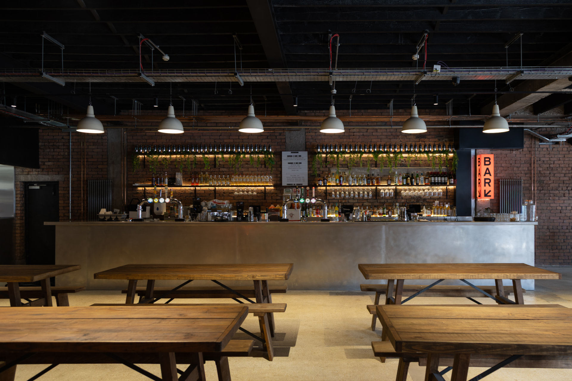 The bar and seating inside Hatters Food and Drinks Hall